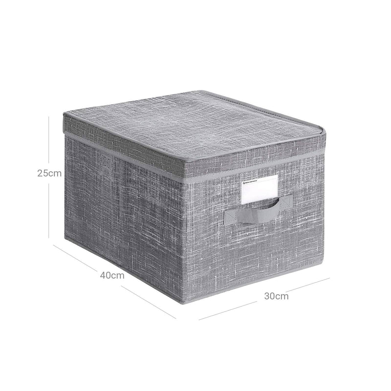 Storage boxes styled in a bedroom setting holding folded clothing