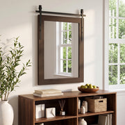 Farmhouse wall mirror hung above a wooden storage unit beside a window