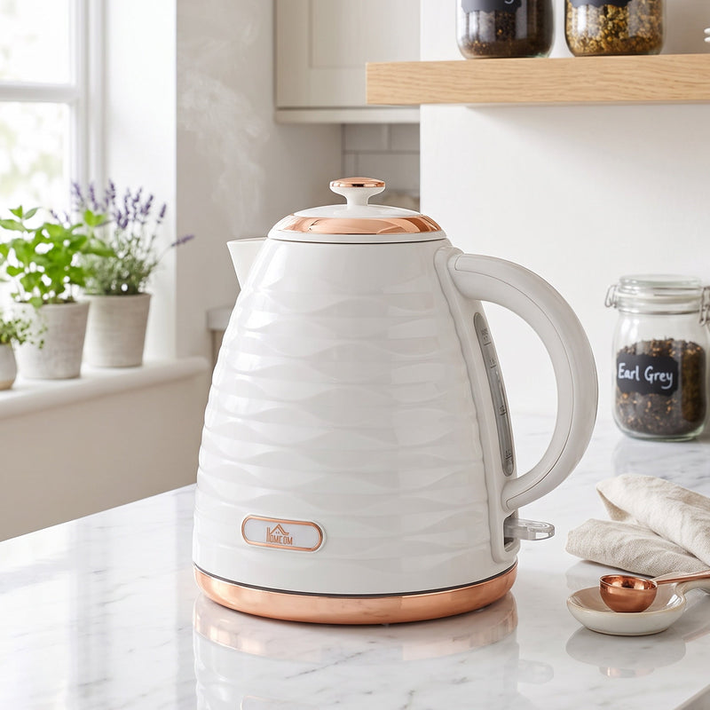 Kettle on a marble kitchen worktop beside potted herbs and a jar of Earl Grey tea