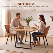 Couple dining at a table with two brown Homcom faux leather chairs