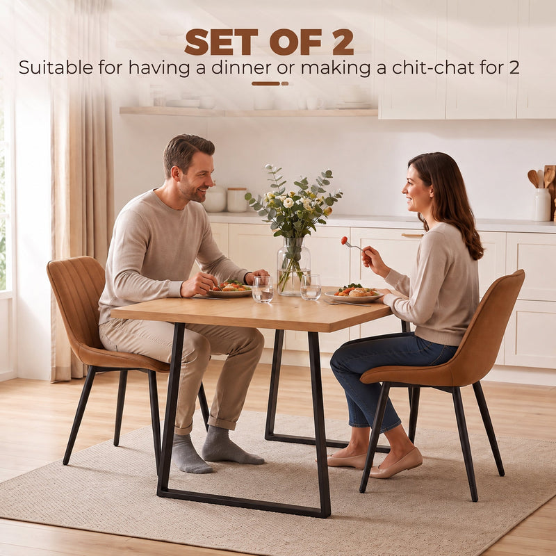 Couple dining at a table with two brown Homcom faux leather chairs