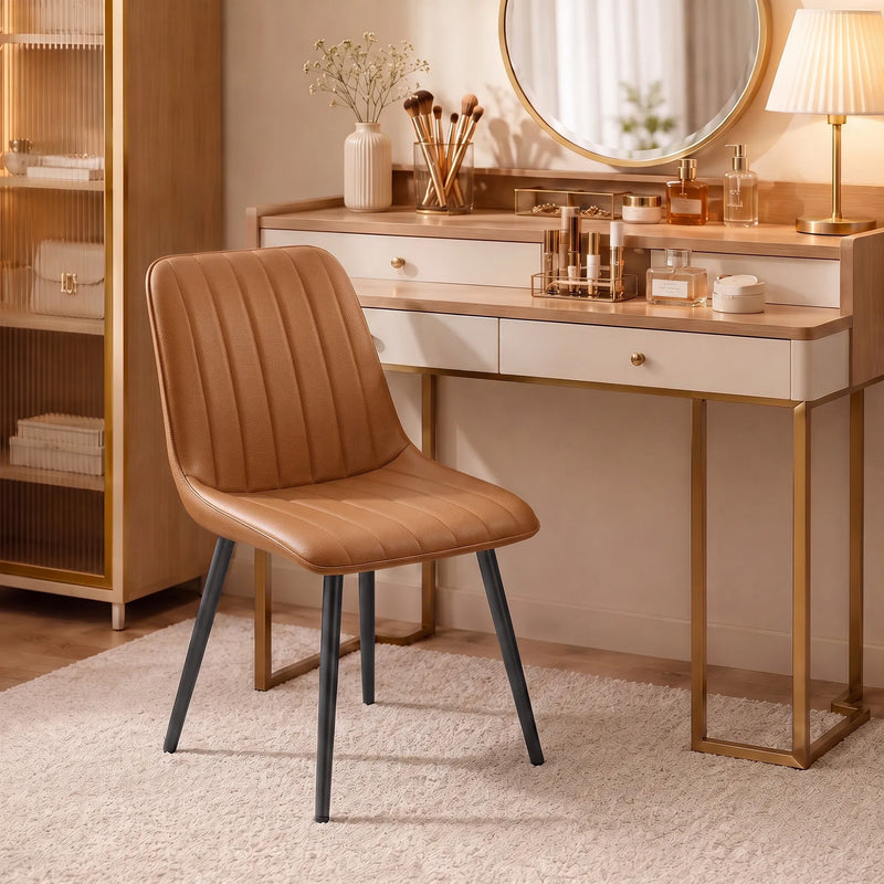 Brown faux leather dining chair beside a dressing table with a round mirror