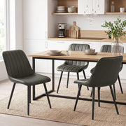 Grey faux leather dining chairs paired with a dining table in a modern kitchen