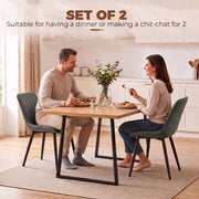 Couple dining at a table with two grey Homcom faux leather chairs
