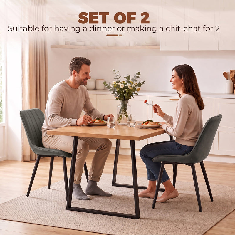 Couple dining at a table with two grey Homcom faux leather chairs