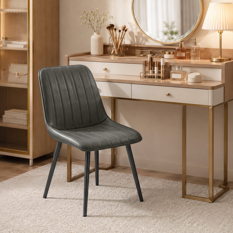 Grey faux leather dining chair beside a dressing table with a round mirror