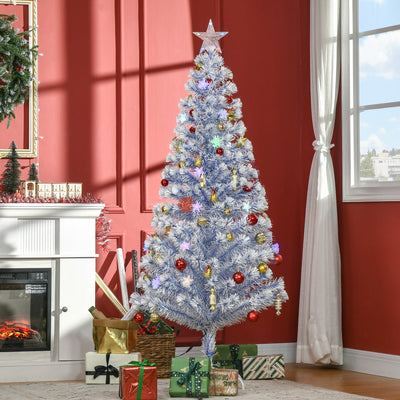 White and blue Christmas tree dressed with red and gold baubles in front of a window