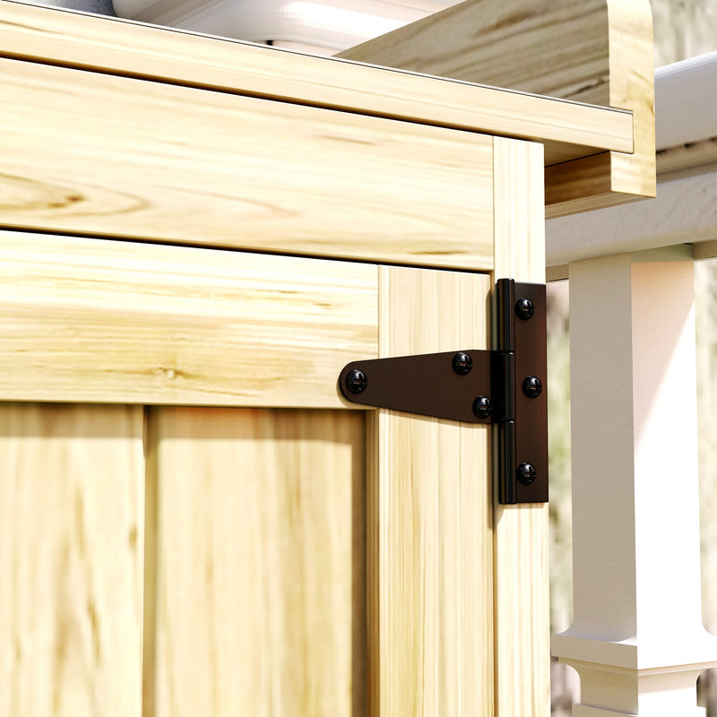 Close-up of the black metal hinge fixing the door to the fir wood shed frame
