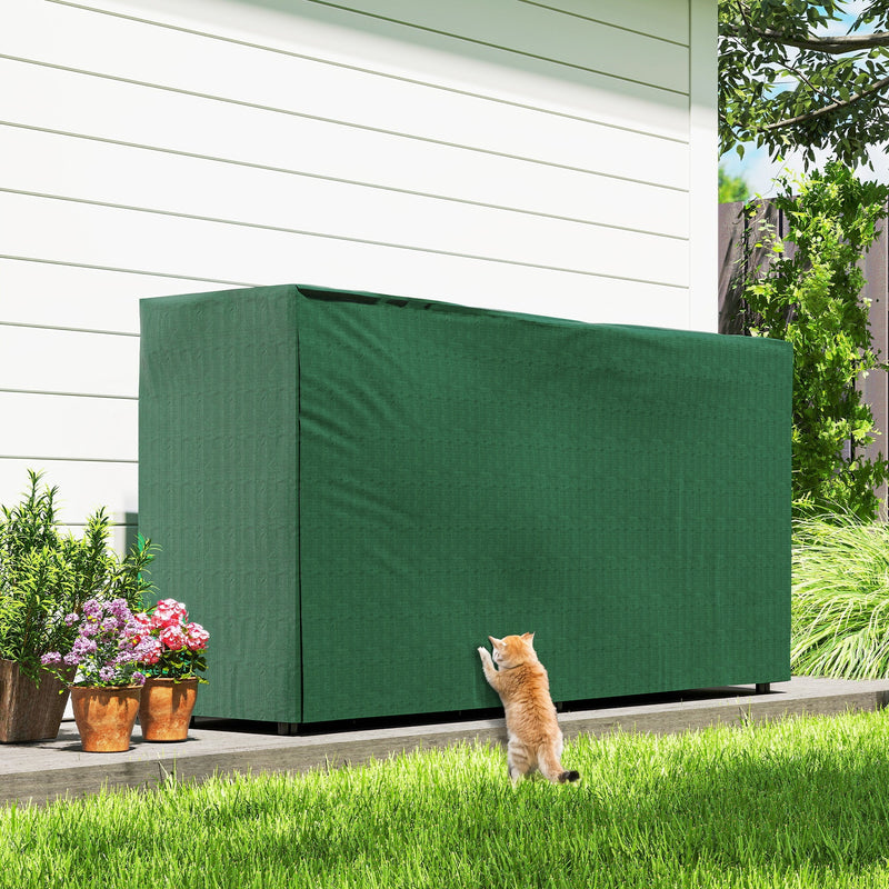 Covered firewood rack in dark green beside potted flowers with a cat nearby