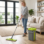 Woman mopping a living room wood floor with the bucket beside her