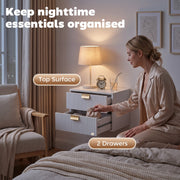Woman opening the lower drawer of the white unit, top surface and 2 drawers labelled