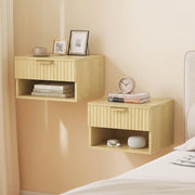 Oak nightstands mounted either side of a bed with books and decor