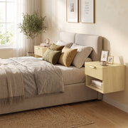 Oak nightstands either side of a bed in a sunlit bedroom