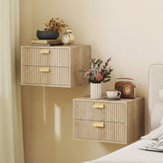 Two oak nightstands wall-mounted at different heights beside a bed with decor on top