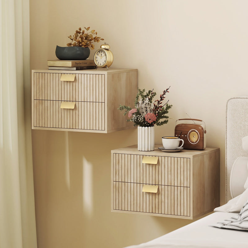 Two oak nightstands wall-mounted at different heights beside a bed with decor on top