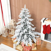 5ft flocked Christmas tree on a brown wall beside a fireplace with red stockings