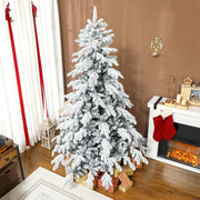 7ft flocked Christmas tree on a brown wall beside a fireplace with red stockings
