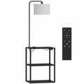 Black floor lamp with 3-tier shelf table, white fabric shade and remote control on a white background