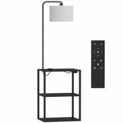 Black floor lamp with 3-tier shelf table, white fabric shade and remote control on a white background