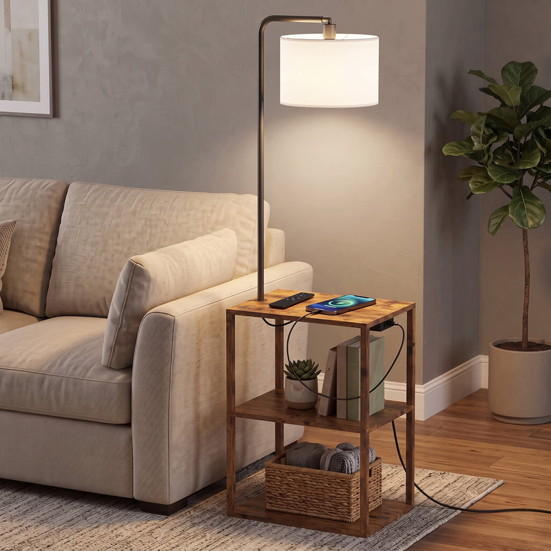 Rustic brown floor lamp with shelf table beside a beige sofa with a phone charging on the top shelf