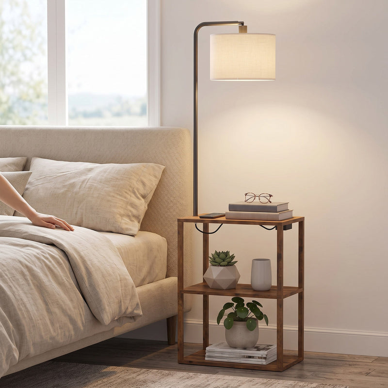 Rustic brown floor lamp with shelf table at a bedside with a plant and glasses on top