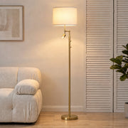 Gold floor lamp with reading light beside a cream sofa and shuttered doors