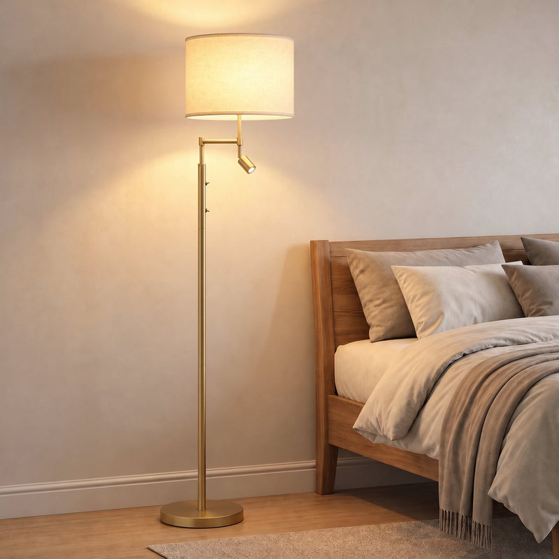 Gold floor lamp glowing beside a bed in a warm bedroom