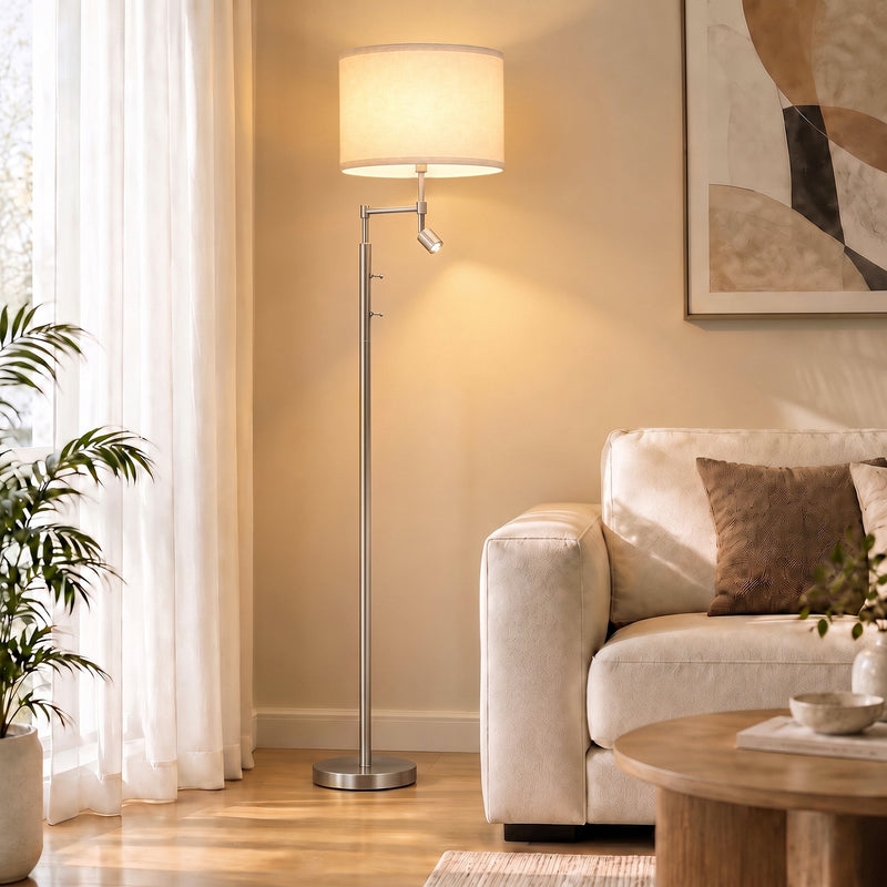 Silver floor lamp next to a cream armchair and side table in a bright room
