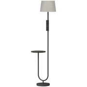 Black floor lamp with linen shade and round black shelf on a white background