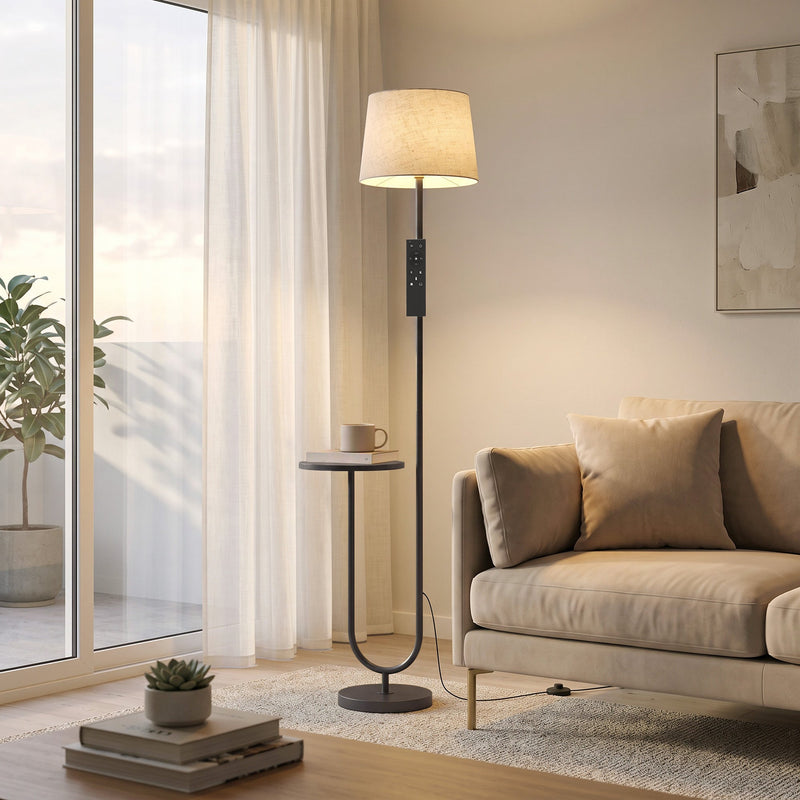 Black floor lamp with shelf by a bright window next to a beige sofa