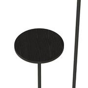 Close-up of the round black wood-grain shelf on the black floor lamp