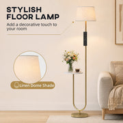 Close-up of the linen dome shade on the gold floor lamp beside a sofa