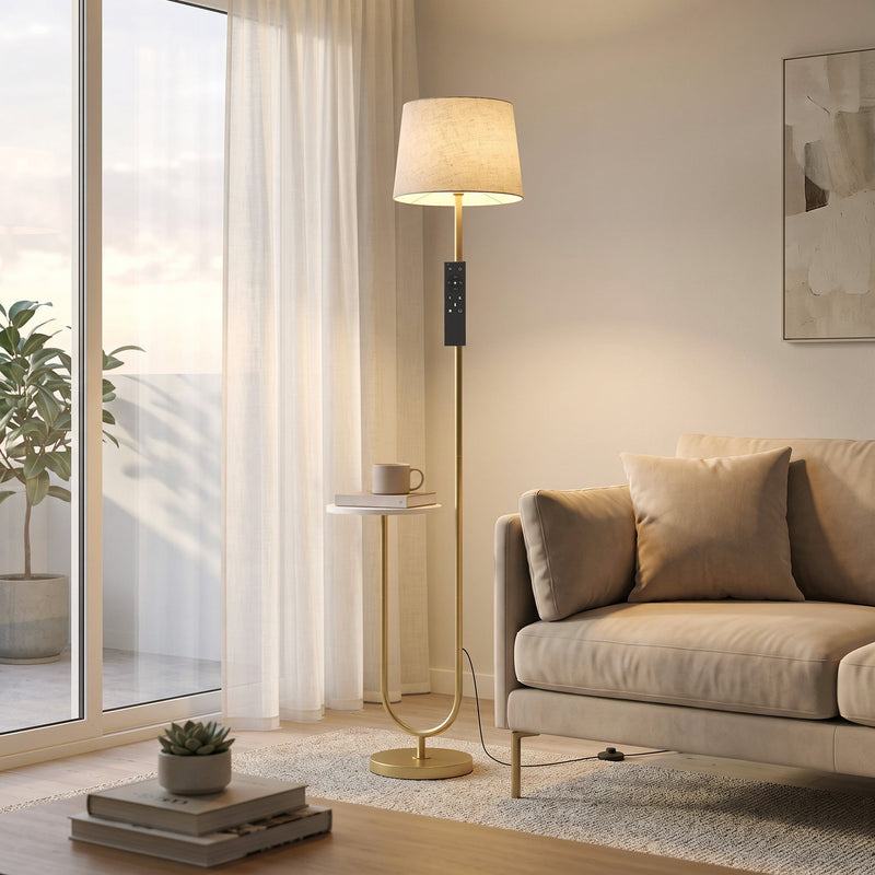 Gold floor lamp with shelf by a bright window next to a beige sofa