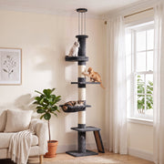Cat tree by a window with cats on the perches and hammock