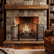 Fireplace screen in a rustic living room with a lit fire behind it