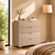 Natural wood chest of drawers styled in a bedroom beside a floor lamp and bed