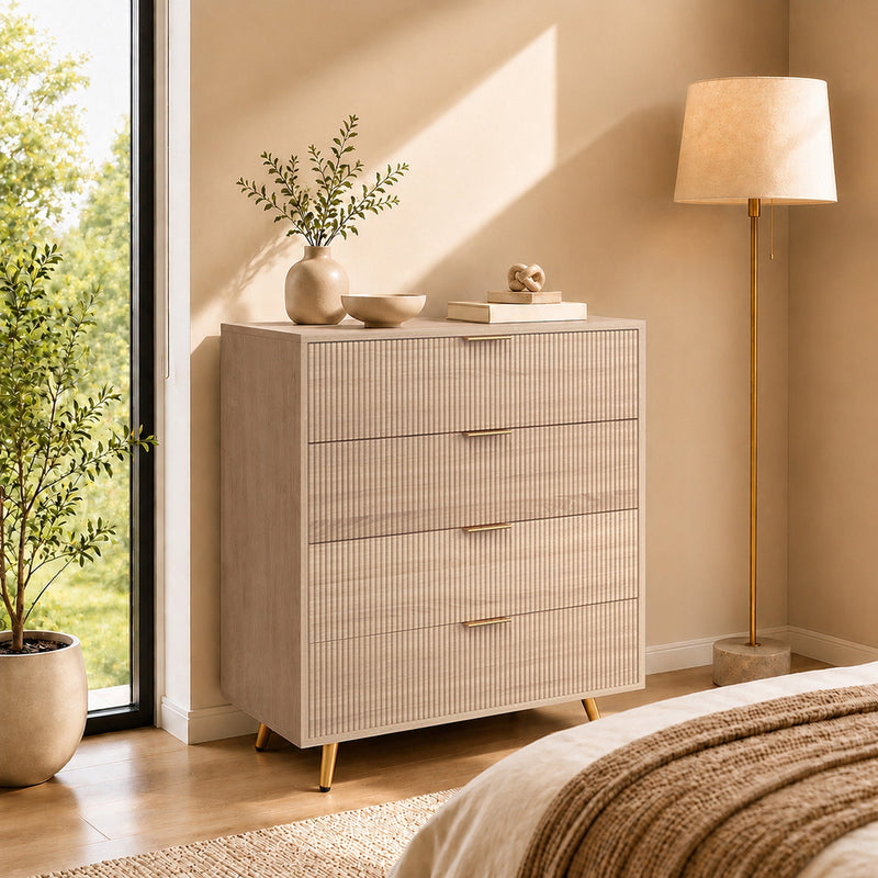 Natural wood chest of drawers styled in a bedroom beside a floor lamp and bed