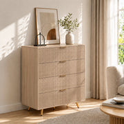 Natural wood chest of drawers styled in a bedroom beside curtains and a coffee table