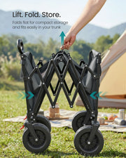 Hand lifting the dove grey cart folded flat for storage beside a tent