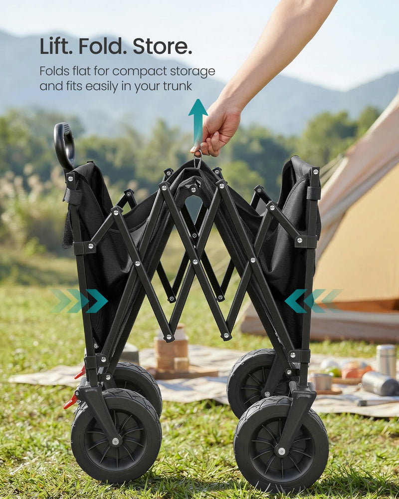 Hand lifting the ink black cart folded flat for storage beside a tent