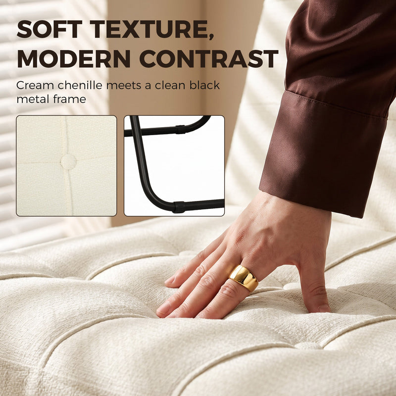 Hand pressing the tufted cream white chenille seat beside a black metal frame detail