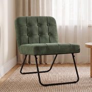 Light green foldable accent chair beside a window on a woven rug