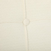 Close-up of a button and stitching on the cream white chenille seat