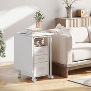 White desk folded into a slim 3-drawer unit used as a side table with books and a plant on top