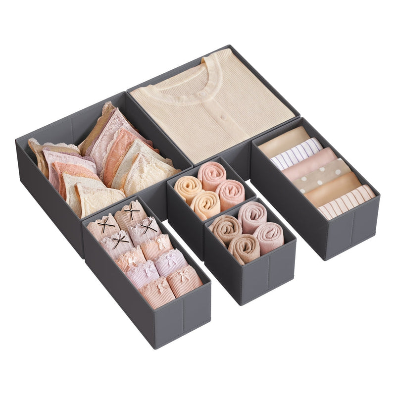 Six dark grey fabric drawer organisers filled with folded clothes and underwear