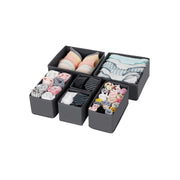 Set of 6 grey drawer organiser boxes arranged together holding bras, socks and ties
