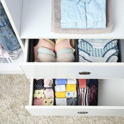 Grey fabric organisers inside two open white drawers holding underwear and socks