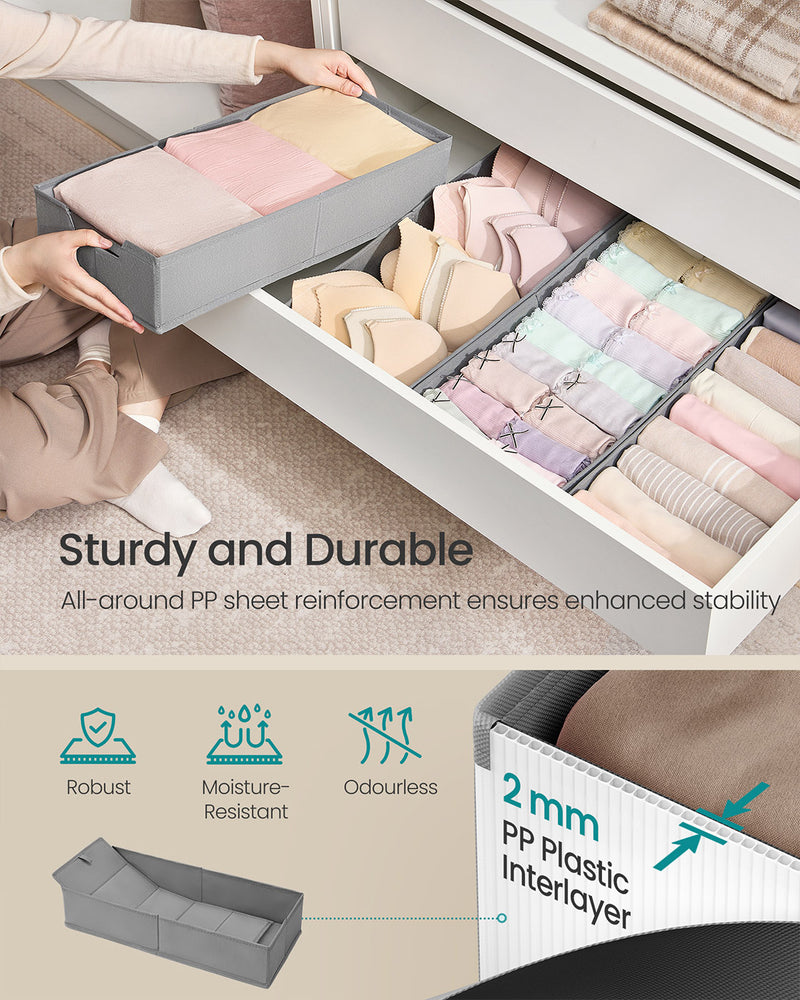 Grey fabric drawer organiser fitted inside a wardrobe drawer with folded clothes