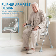 Older man in a dressing gown sitting on the shower chair using the flip-up armrest for support