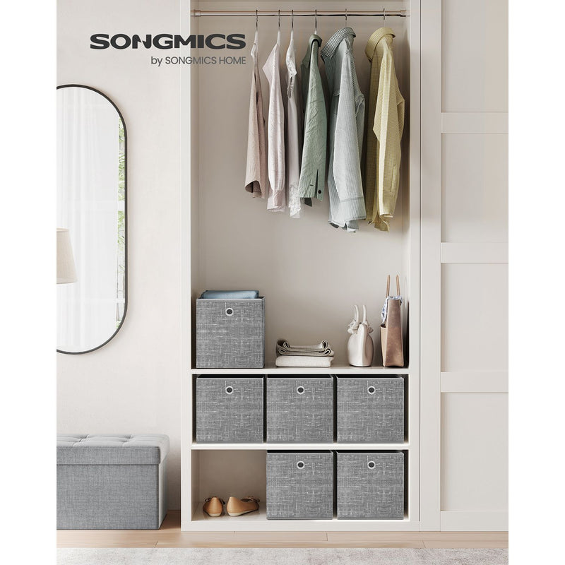 Heathered grey storage cubes on open wardrobe shelving next to hanging clothes